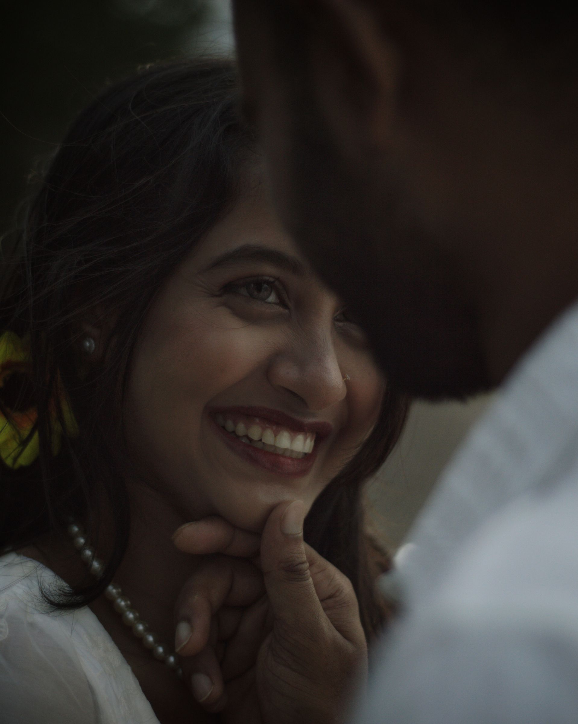 A woman laughing as her partner leans in close