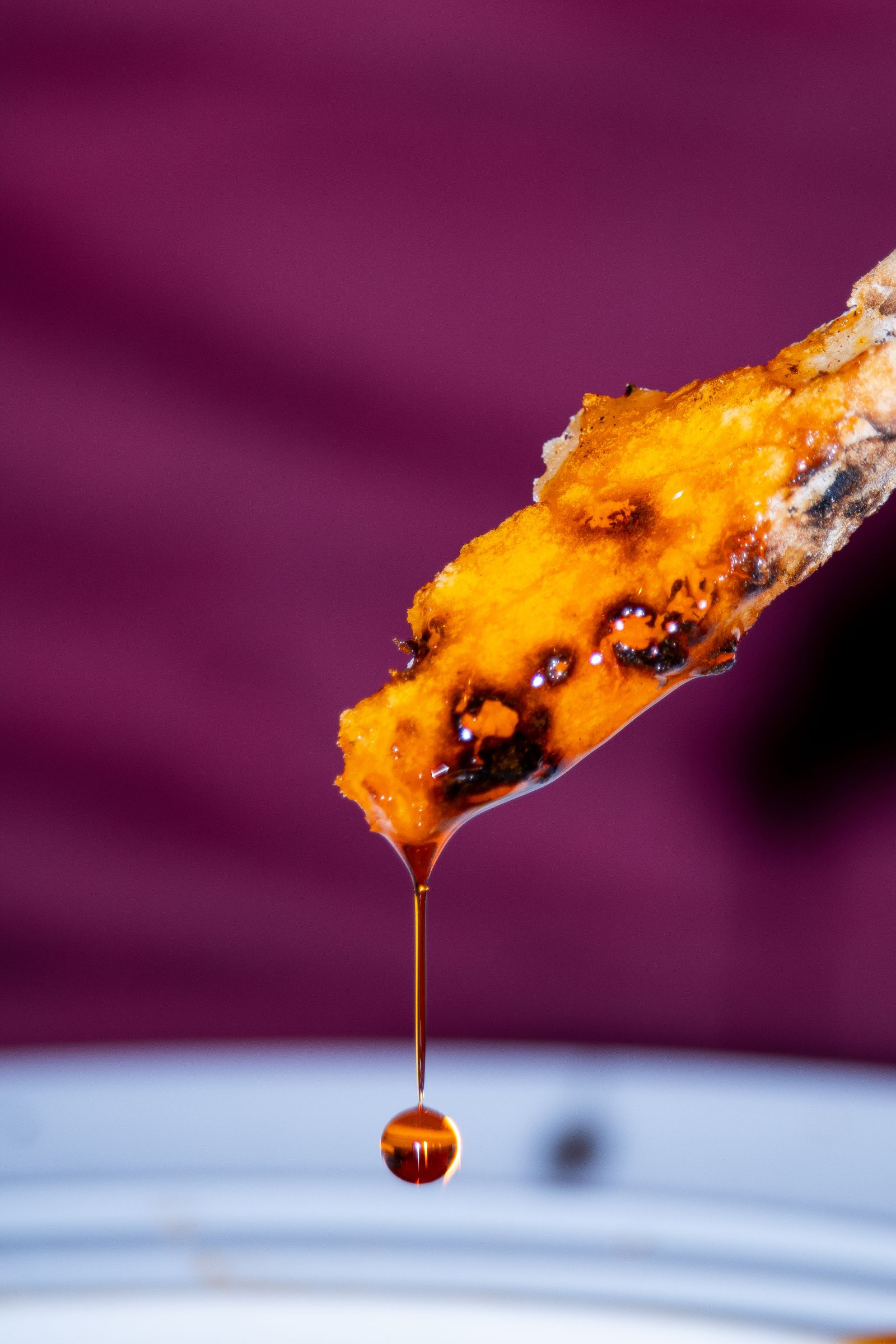Caramelised topping dripping from a spoon